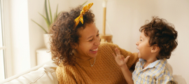 cozy mom and child smiling and laughing